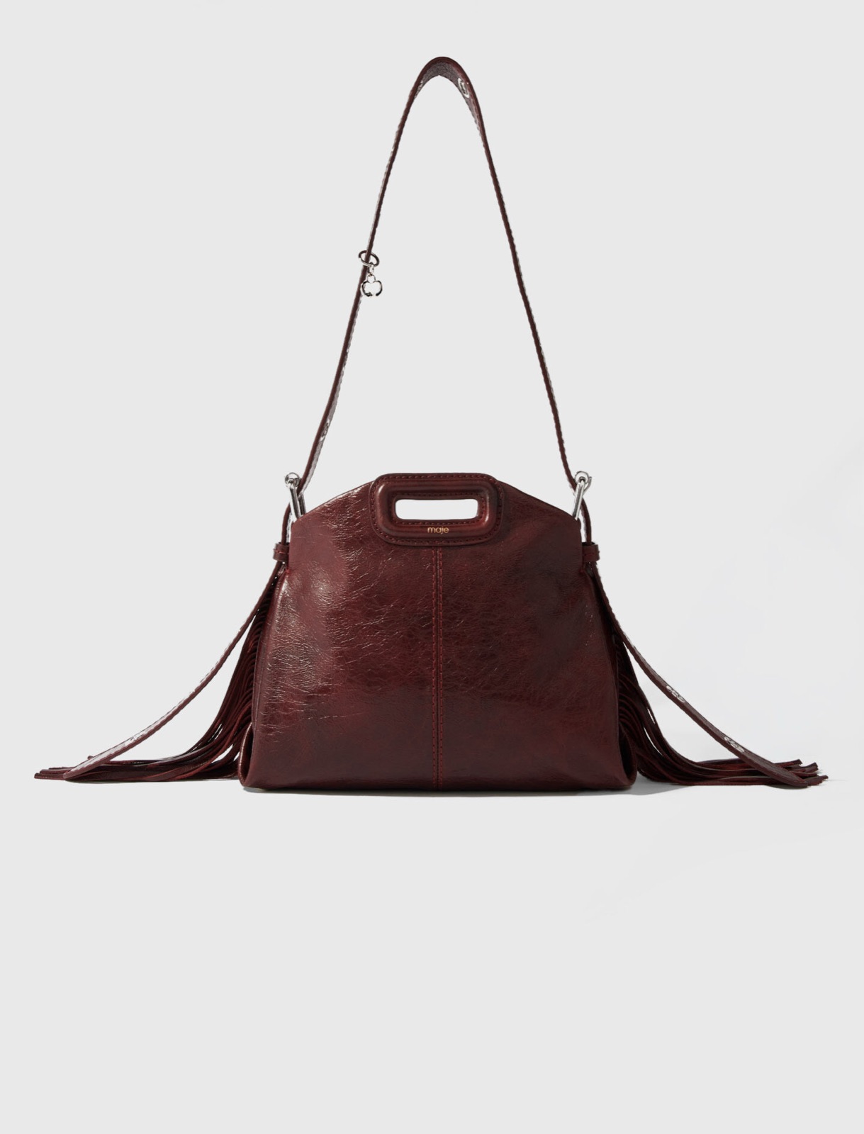 Sac Miss M mini de Maje en cuir craquelé bordeaux, franges et rivets argentés, bandoulière