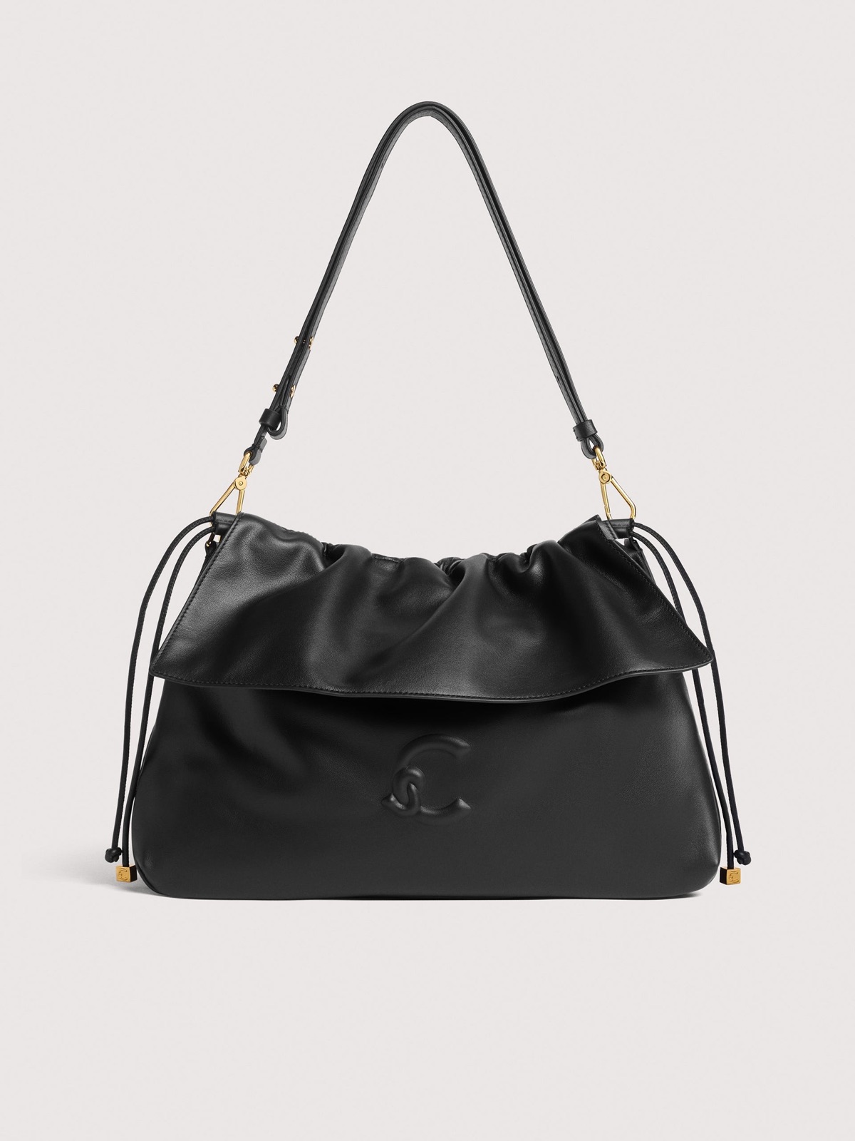 Sac Lidia medium de Coccinelle en cuir noir, haut froncé, logo C-Me en relief et cordons à embouts dorés